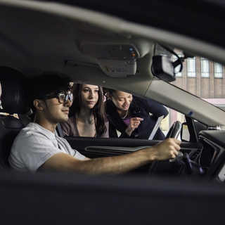Students collaborate using a driving simulator in the UMass Center for Transportation.